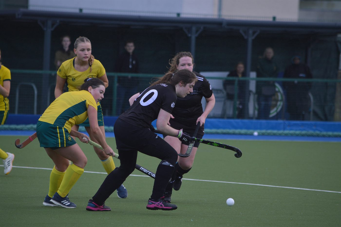 Navan Hockey Club players competing for the ball on the pitch